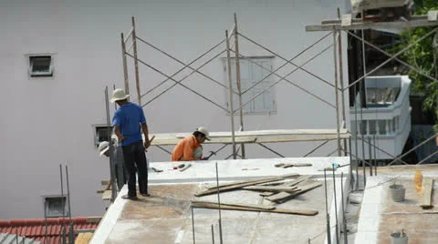 Three Asian builders are working on building a house Stock Footage 26212373