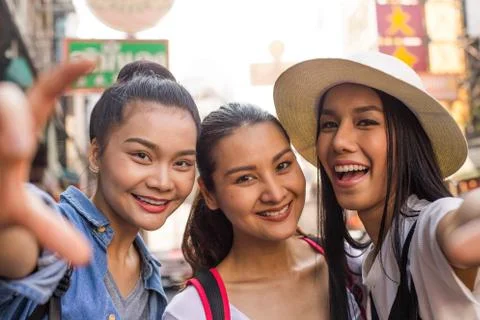 Three asian girls are taking a selfies when they are in bangkok trip. Stock Photos