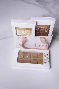 Three assorted chocolate bars gift wrapped vertical. Stock Photos