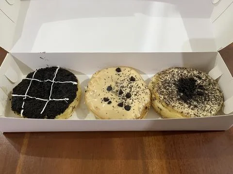 Three assorted donuts in a box. Stock Photos
