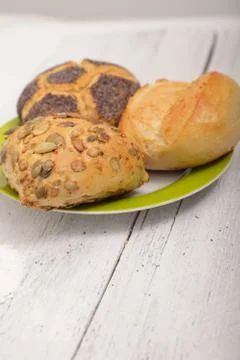 Three assorted rolls on a plate Stock Photos