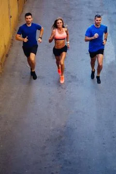 Three athletes jogging Stock Photos