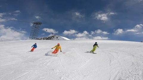 Three Athletes Ski from the Hill in a Synchronized Manner in the French Alps Stock Footage 105586183