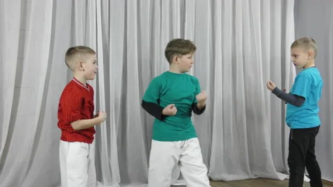 Three athletes train blocks and kicks to meet each other Stock Footage 150208216