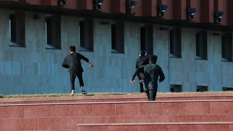 Three athletic young men after overcoming obstacles running forward Stock Footage 106860976