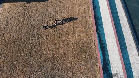 Three athletic young men overcoming obstacles and running from the grass on the Stock Footage 106869321
