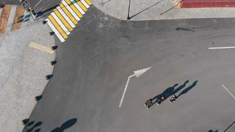 Three athletic young men running on the road and about to performing tricks. Stock Footage 106866524