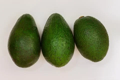 Three avocado on a white background. Avocado macro. Close up of an avacado Stock Photos