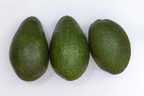 Three avocado on a white background. Avocado macro. Close up avacado. Avocado Stock Photos