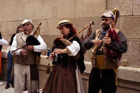 Three bag pipers play celtic music in a history festival in Vigo Stock Photos