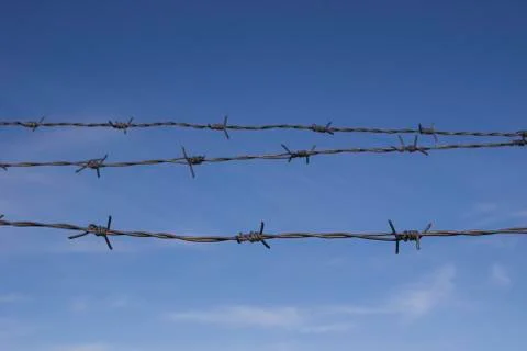 Three barbed wire and sky Stock Photos