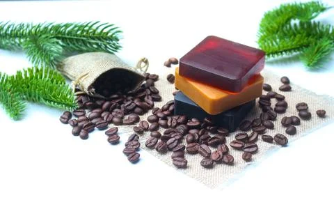 Three bars of handmade coffee and bamboo glycerin soaps with roasted coffee b Stock Photos