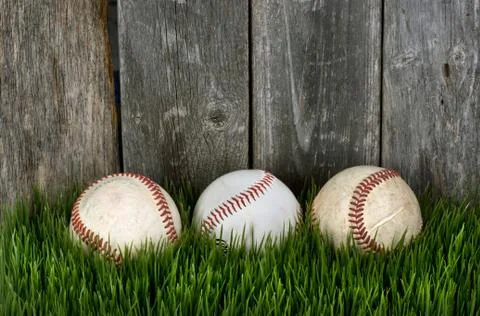 Three Baseballs on grass. Stock Photos