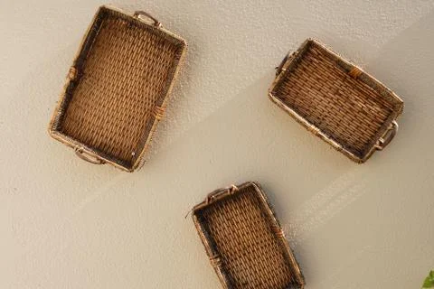 Three baskets hanging on the wall Stock Photos