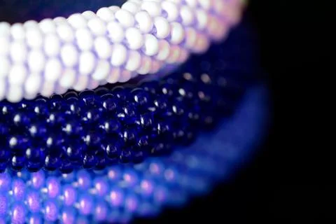 Three beaded bracelets on a dark background close up Stock Photos
