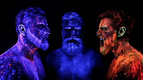 Three bearded men in UV powder are standing static Stock Footage 92349585