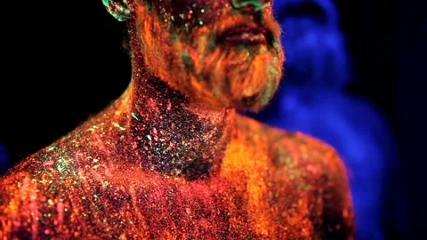 Three bearded men in UV powder are standing static Stock Footage 110871237