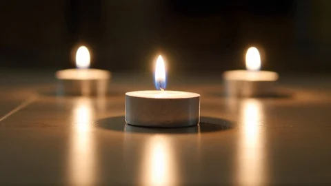 Three beautiful burning candles on the table Stock Footage 87418791