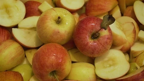 Three beautiful multicolored ripe apples on background of sliced vitamins for Stock Footage 122330205