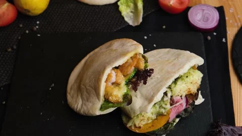 Three beautiful pitas lie on a black background, they are taken in hand Vegan Video stock 138746571