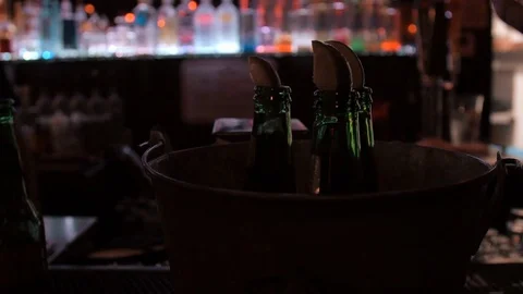 Three beers with limes in a bucket at dark bar Stock Footage