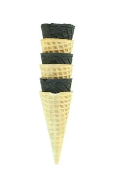 Three beige and three black stick ice cream cones stacked with alternating co Stock Photos