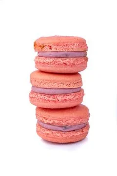 Three berry macarons stacked isolated over white background Fotos Stock