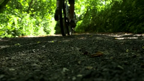 Three Bicycle Tires Pass Camera Close-up on Gravel Road Stock Footage 265129974