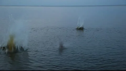 Three big splashes from rocks dropped into the water Stock Footage 10892815