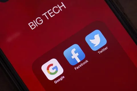 Three big tech corporations applications on smartphone screen Stock Photos