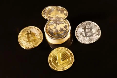 A three bitcoin arround pipe with silver litecoin Stock Photos
