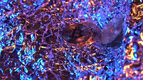 Three BITCOIN BTC rotate in frame with gold and blue light and amazing Stock Footage 129804920