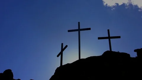 Three black Catholic crosses with dawn behind Stock Footage 105292867