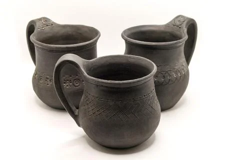 Three black ceramic mugs on a white background Stock Photos