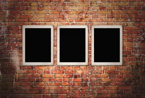 Three black frames on brick wall Stockillustratie