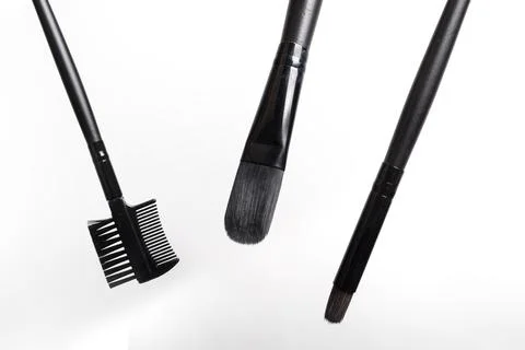 Three black makeup brushes on a white background Stock Photos
