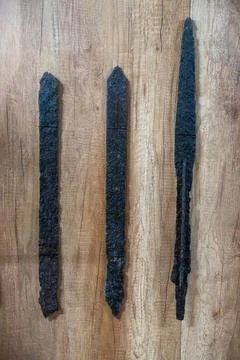 Three black objects are on a wooden surface. in Chennai 写真素材