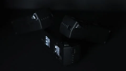 Three black uas drone batteries stacked on top each other against a black Stock Footage 270362404