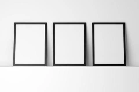 Three blank black photo frames on white shelf Stockillustratie