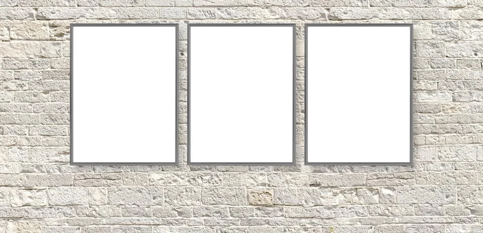 Three blank frames hanging on white brick wall Stock Photos