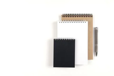 Three blank notepads and pen Stock Photos