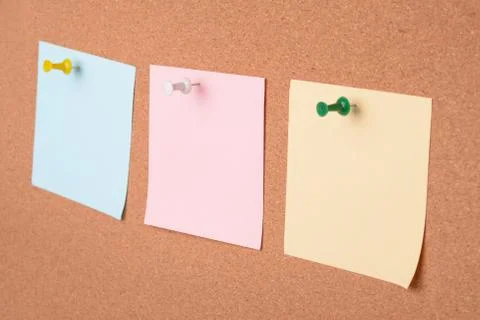 Three blank paper notes on cork board Stock Photos