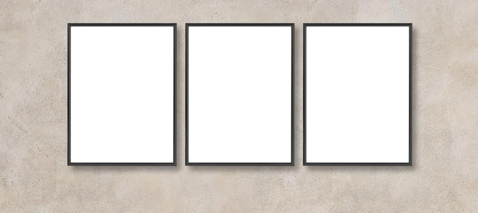 Three blank picture frames on concrete wall mockup Stock Photos