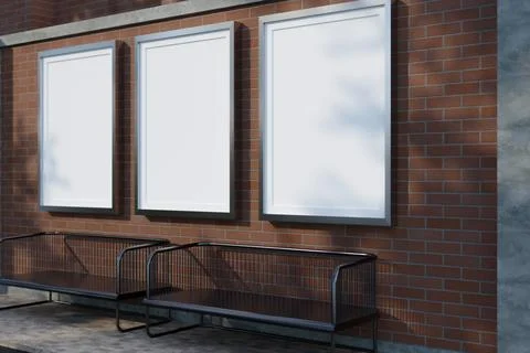 Three blank vertical poster frame mockups on brick wall with benches. Illustrazione stock