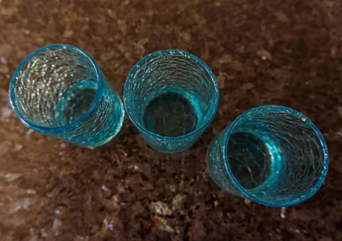 Three blue glasses on a table Stock Photos