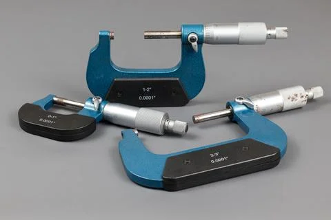 Three blue micrometers with various sizes Stock Photos