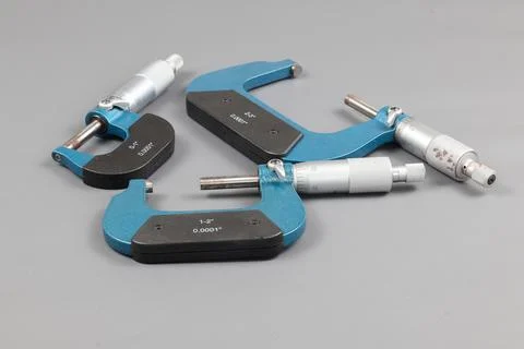 Three blue micrometers with various sizes Stock Photos