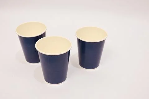 Three blue paper cups, set against a clean white background, providing a si.. Foto stock