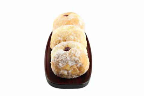 Three blueberry donuts on the dish. Stock Photos