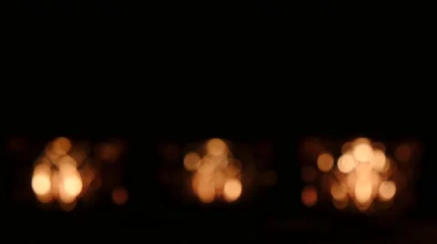 Three blurred crystal tealights in front of black background. Stock Footage 43722323